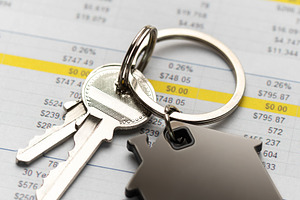 House keys with home charm on financial spreadsheet, a Business Photo by Olena Rudo