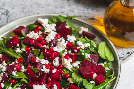 Arugula, Beet and cheese salad with pomegranate and dressing on, a Food & Drink Photo by Ivanna