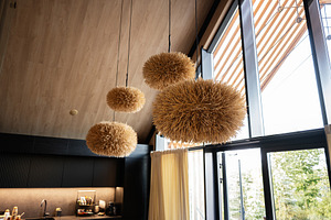Modern interior design with unique pendant lights and natural wood finish, a Photo by AS photostudio
