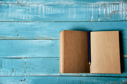 Top view of blank open notebook on blue wooden background with p, a School & Education Photo by Ministocker