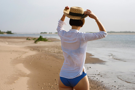 Girl in bikini walks on beach, a Person Photo by Elena Vagengeim