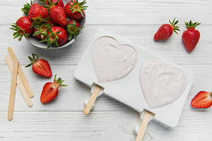 Preparing strawberry yogurt popsicles in heart shaped molds, a Food & Drink Photo by Olena Rudo