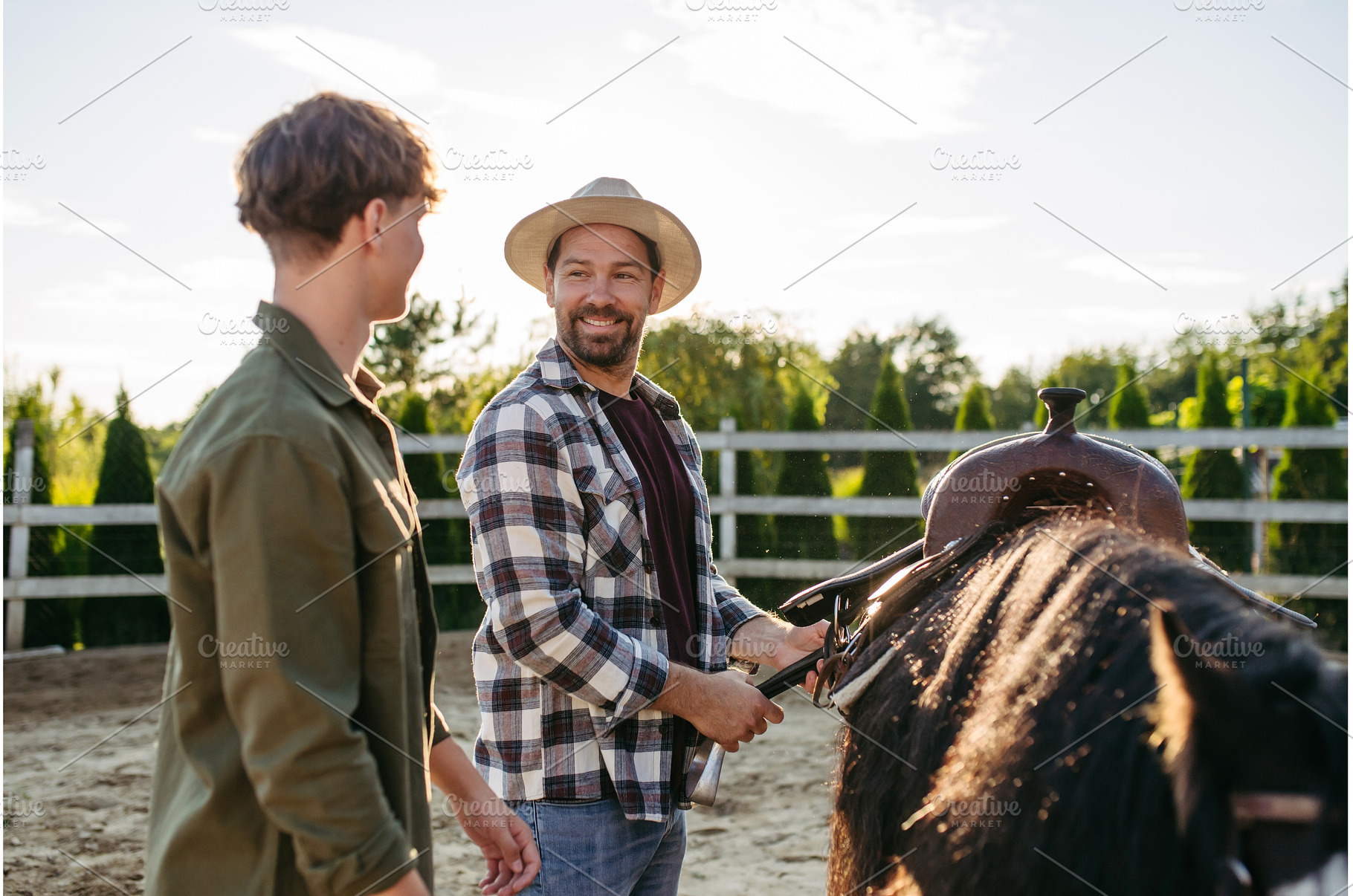 ather and son preparing horse for, a Person Photo by HalfPoint