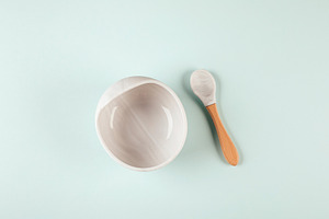 Baby bowl, spoon. Flat lay