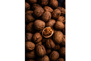 Cracked walnut in pile of whole, a Food & Drink Photo by Yulia Furman