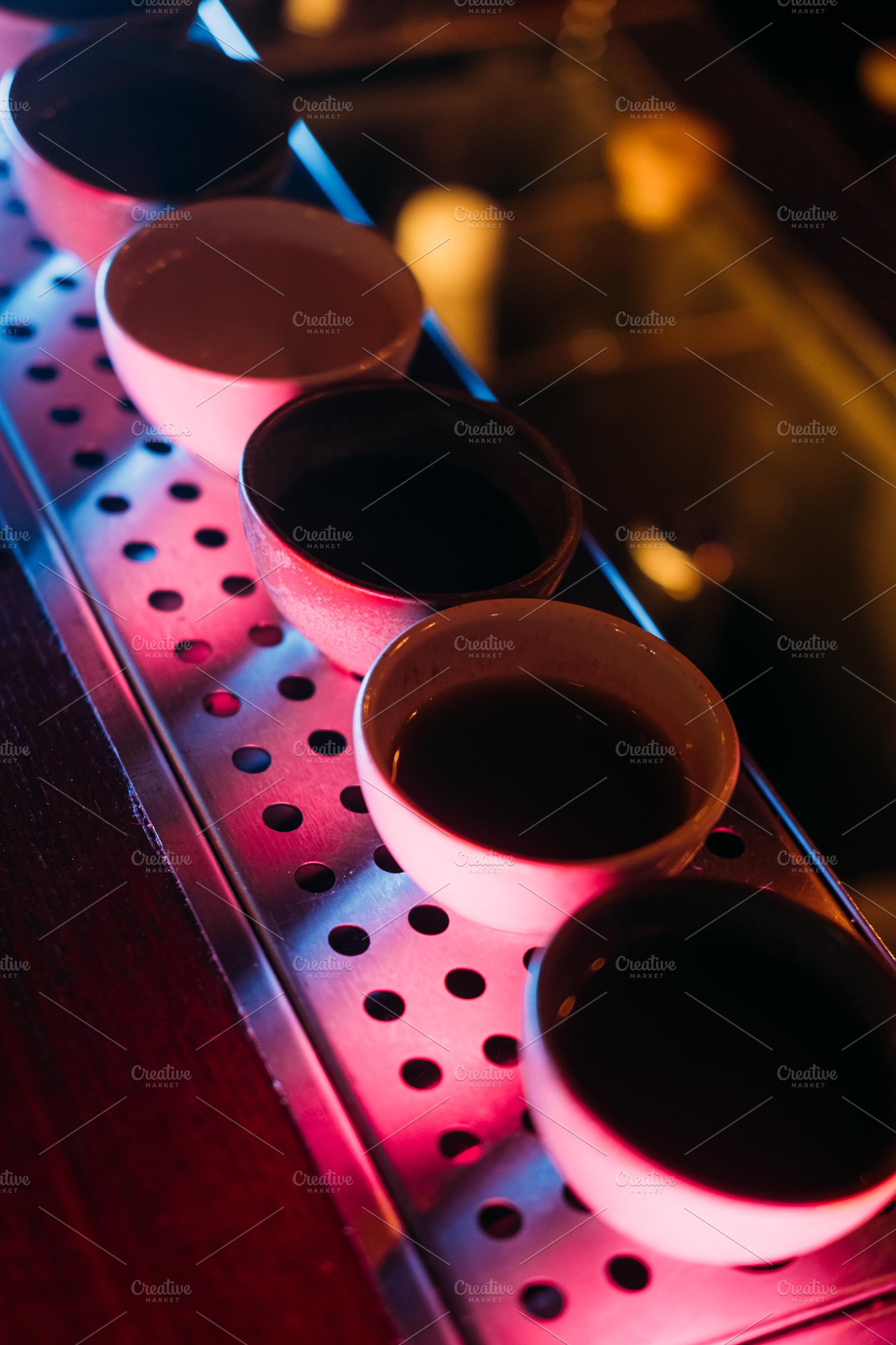 Asian pub sake cup row neon alcoholic pub counter, a Food & Drink Photo by Photo Drive Studio
