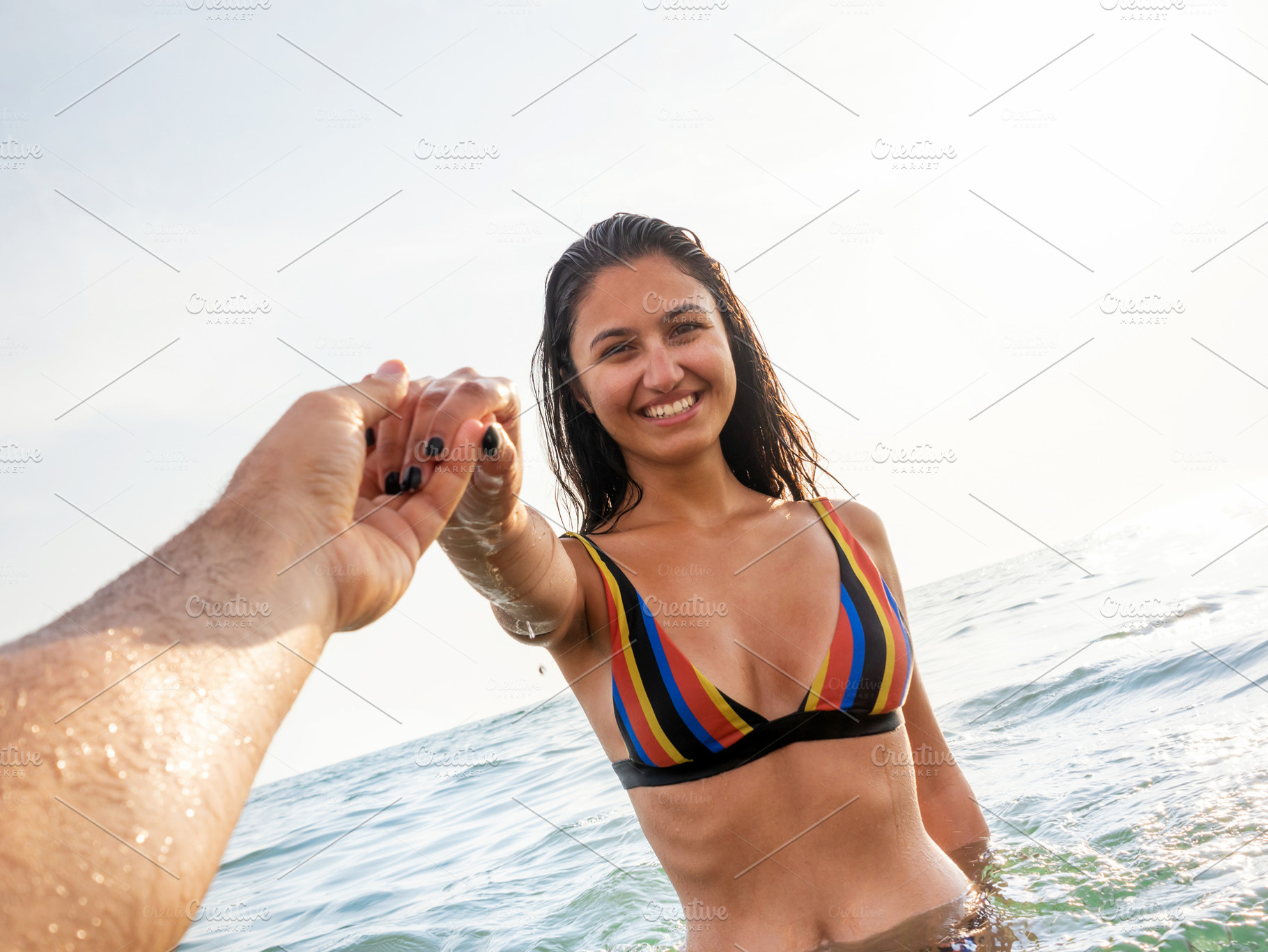 Young woman in bikini takes a bath in the sea at sunset lights i, a Person Photo by Antonio Gravante Market