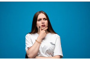 Young woman pondering a difficult, a Person Photo by volodymyrshtun13795