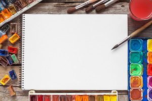 Watercolor paints and sketchbook