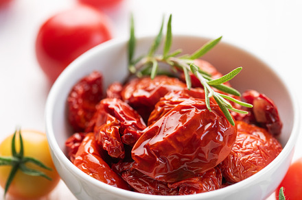 Bowl with sun dried tomatoes with fresh herbs and spices., a Food & Drink Photo by Olena Rudo
