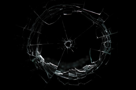 Shattered glass surface, showcasing intricate cracks radiating outward from a c, a Background Photo by Textures & Backgrounds