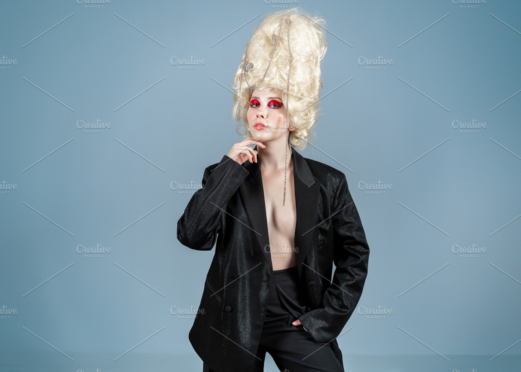 Confident naked female model in blazer and huge blond wig at studio, a Person Photo by andreonegin market
