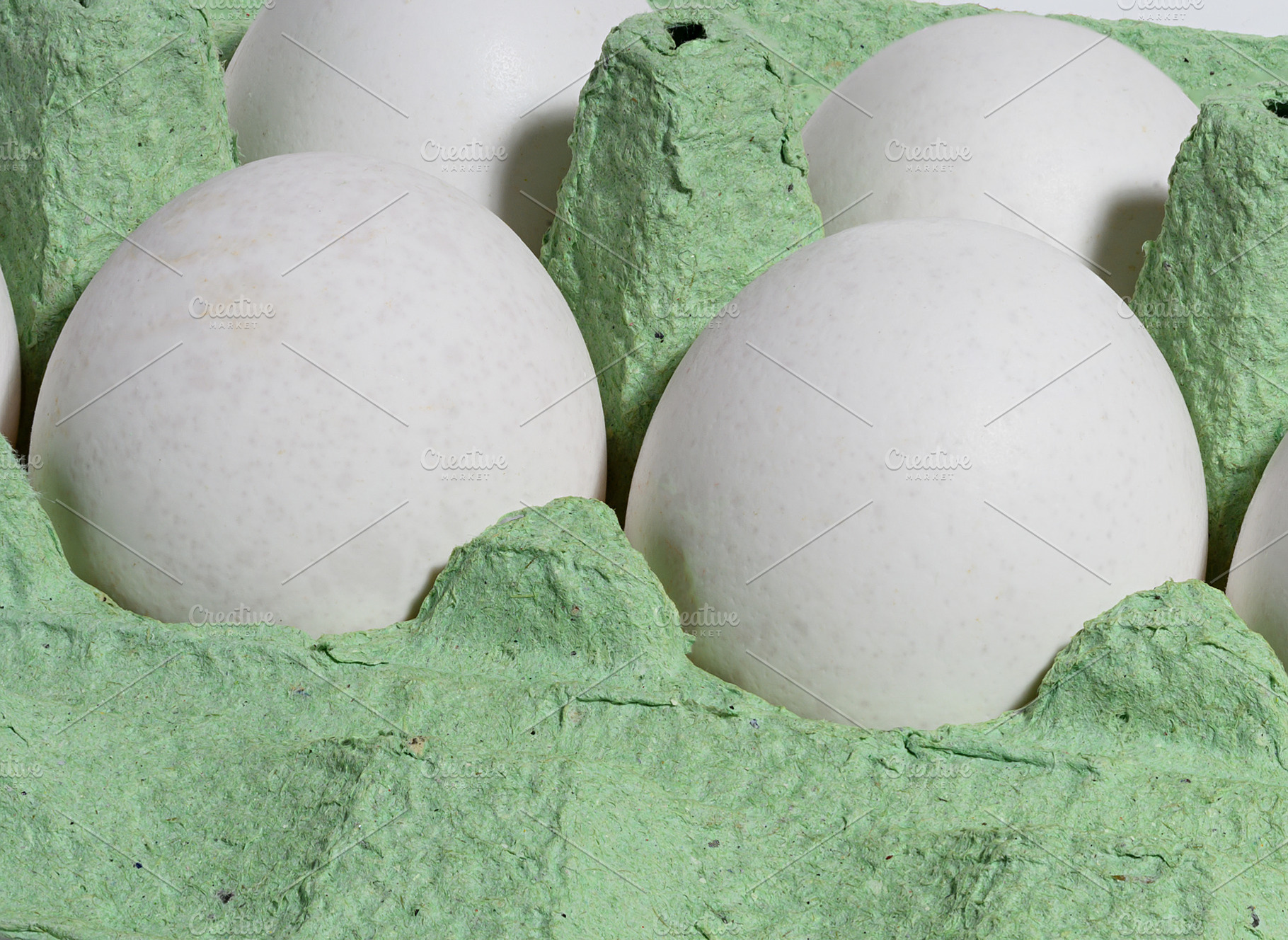 White chicken eggs in a green cardboard tray, a Food & Drink Photo by ndanko