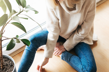 Young woman using her laptop while sitting on the floor at home., a Person Photo by Olena Rudo