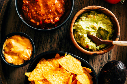 Mexican nachos with guacamole, cheddar cheese and chili.