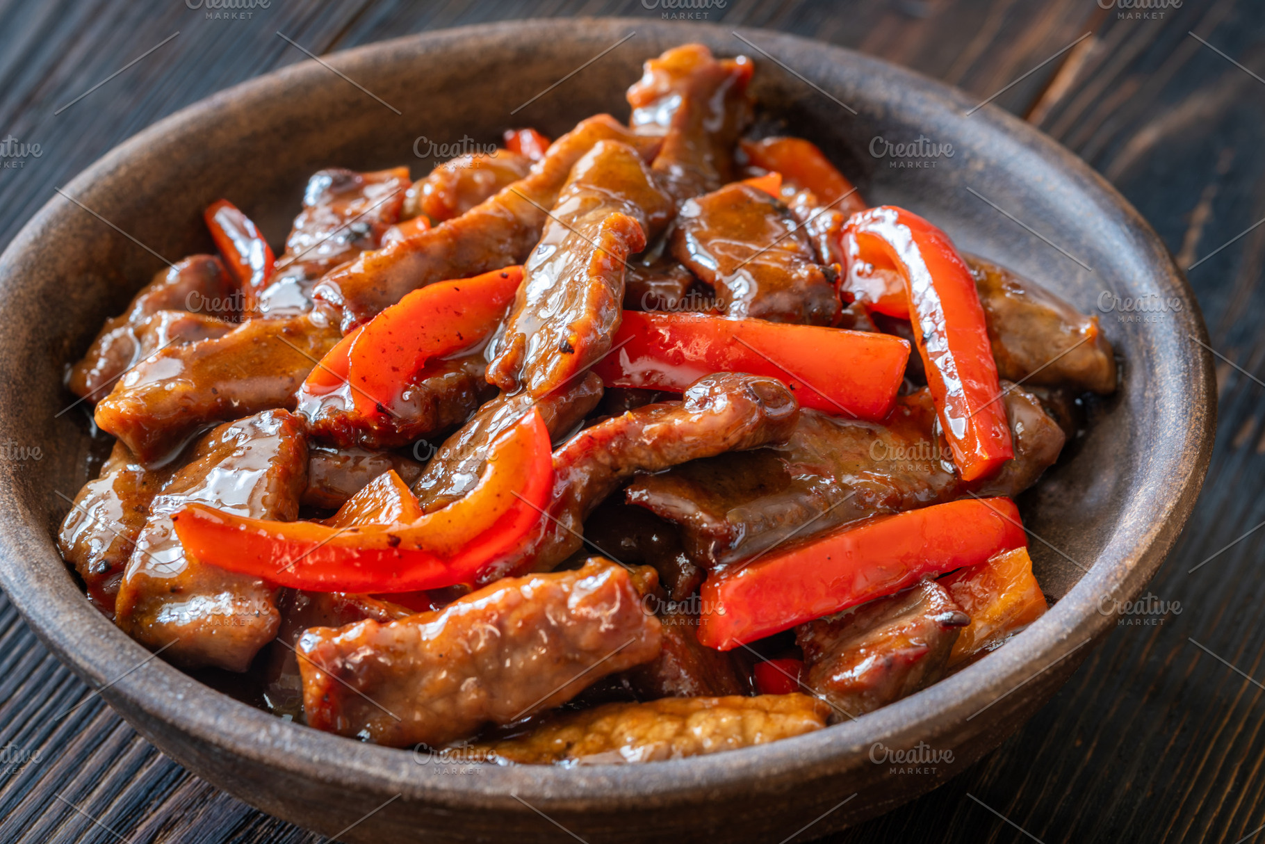 Chinese Beef Stir Fry With Red Peppers In Rustic Earthenware Bow, a Food & Drink Photo by Alexander Prokopenko