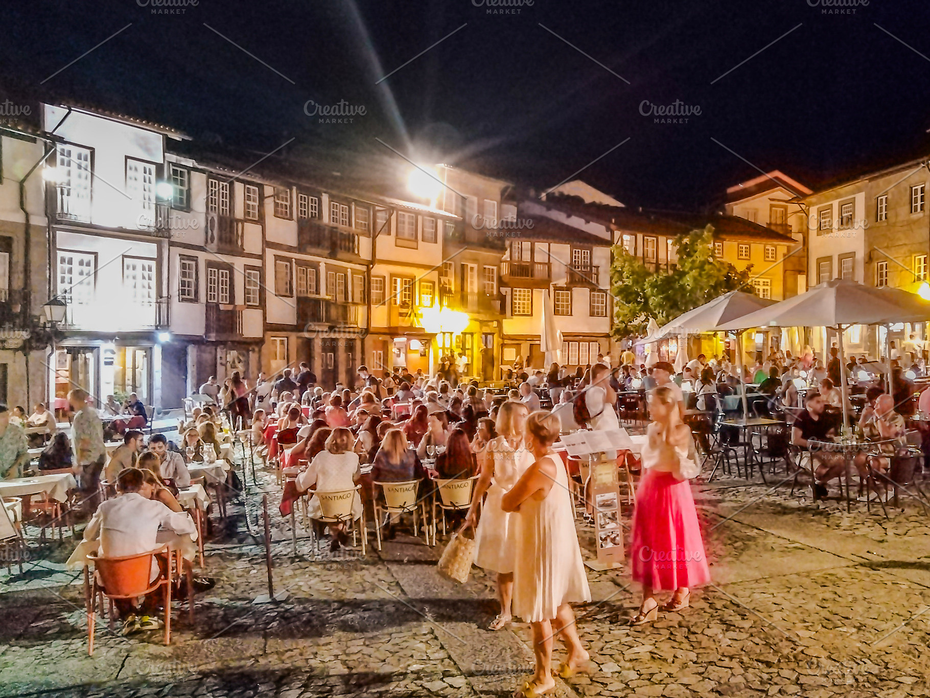 Night crowd dining in historic guimaraes square, portugal, a Person Photo by DanFLCreativo