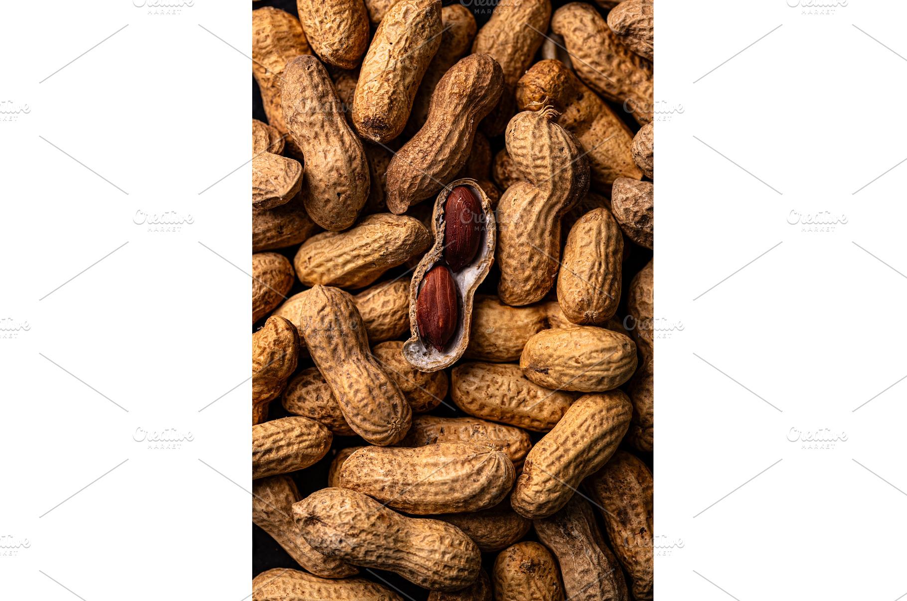 Pile of peanuts with one shell open, a Food & Drink Photo by Yulia Furman
