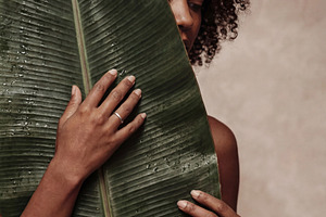 Portrait of Serene Woman with Leaf, a Person Photo by Virgo Studio