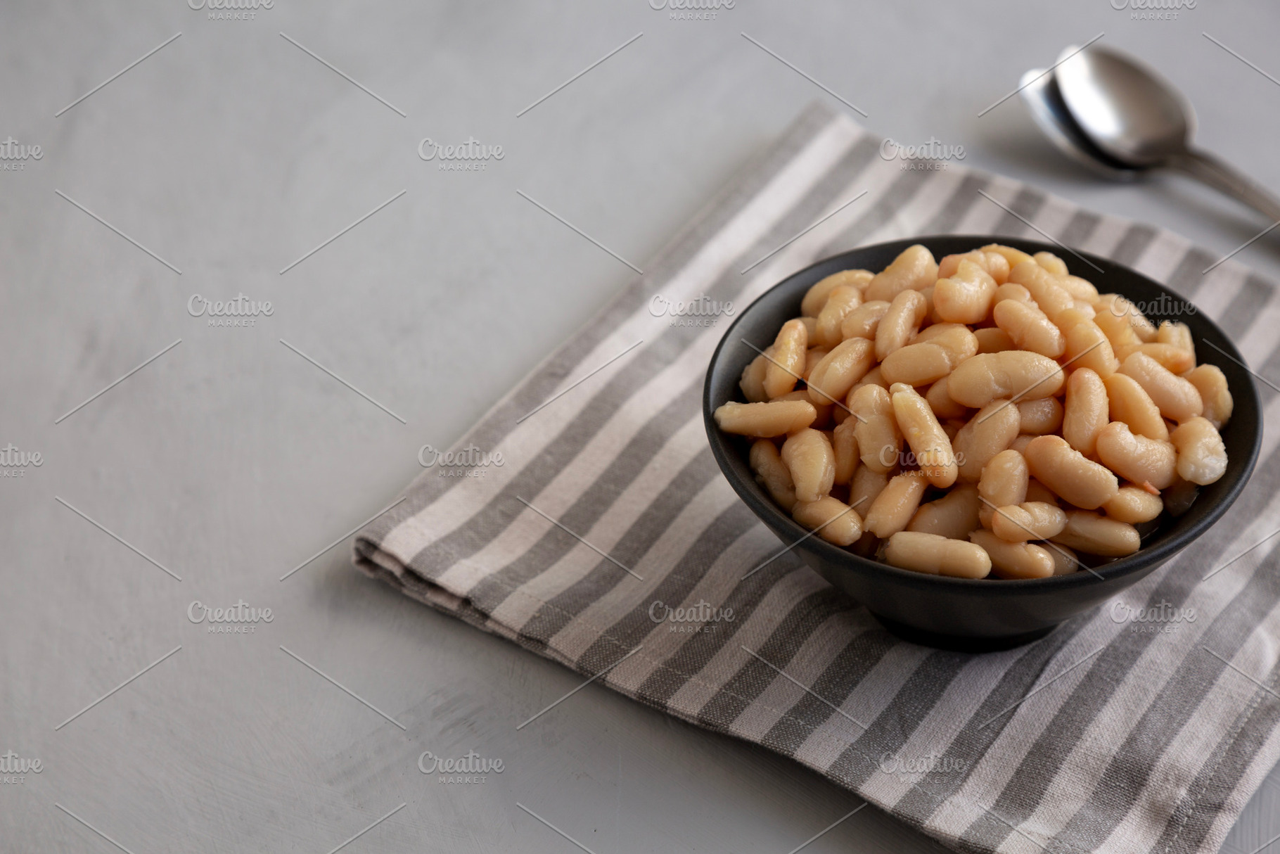 Organic Cannellini Beans in a Bowl, side view. Copy space., a Food & Drink Photo by LiudmylaChuhunova