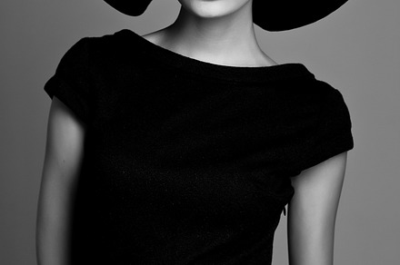Woman retro fashion portrait featuring black, white, and hat
