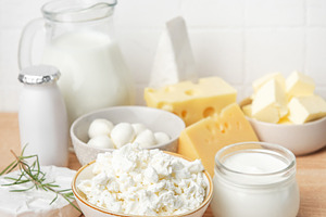 Assortment of fresh dairy products on wooden table, a Food & Drink Photo by Olena Rudo
