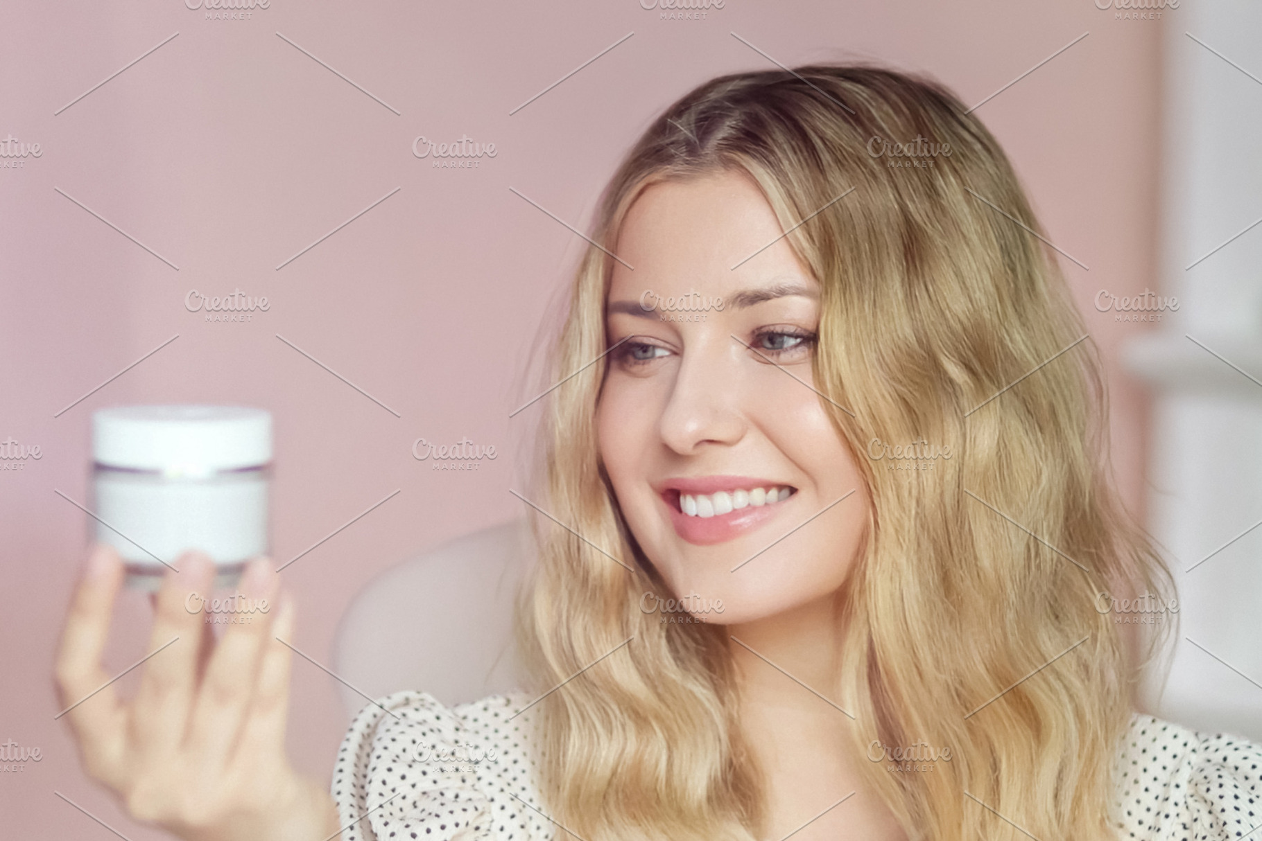 Young woman holding and looking at a blank moisturizer jar, prom, a Person Photo by Studio ANNA