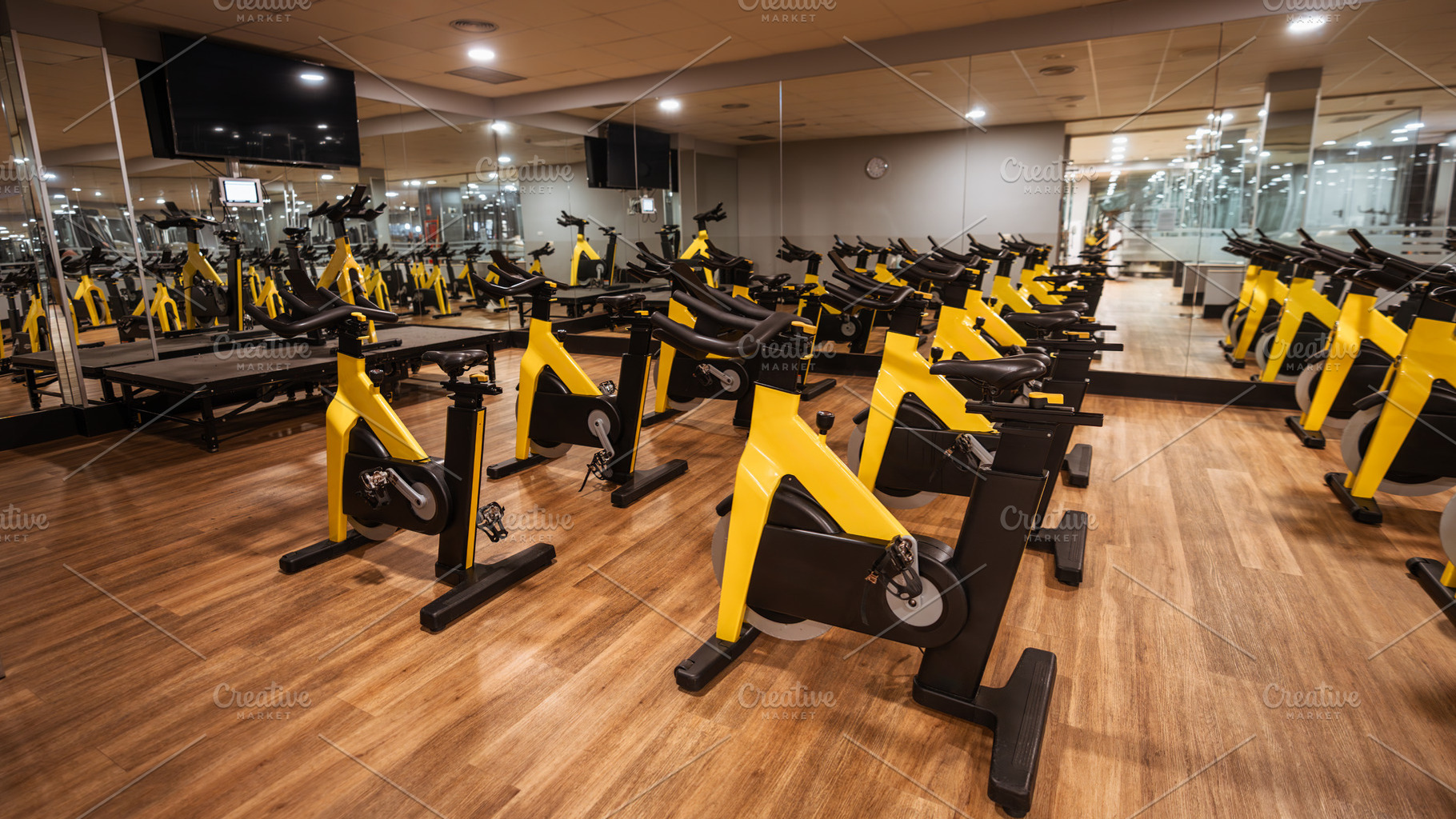 Yellow spin bikes in gym studio, a Sports & Recreation Photo by SkyNext