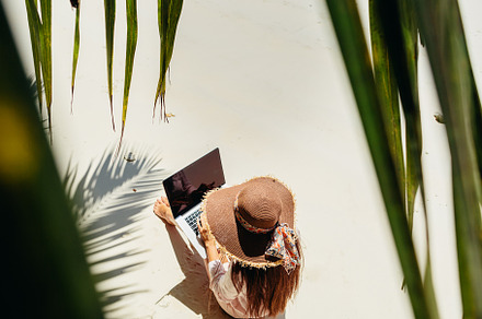 Woman working remotely on laptop on stock photo containing seychelles and, a Person Photo by Olyryk & Aglo