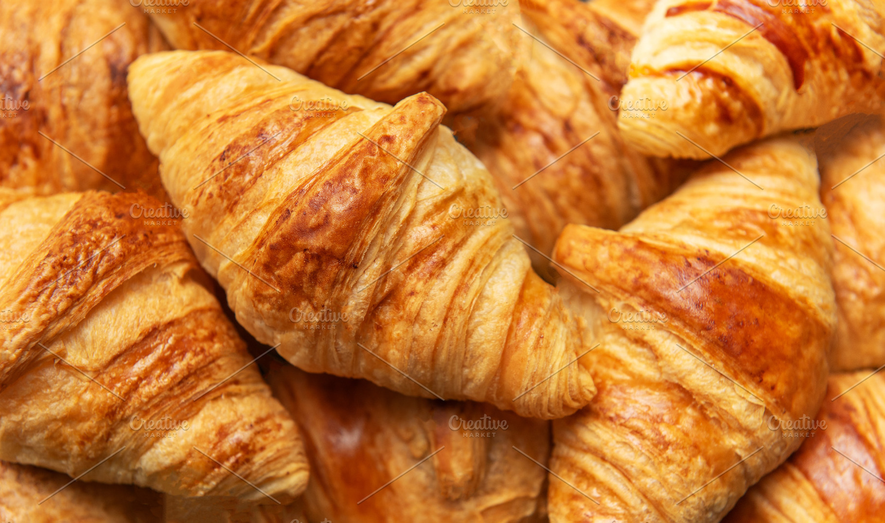 Freshly baked croissants forming an appetising background for fr, a Food & Drink Photo by Olena Rudo
