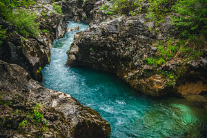 Winding Soca river in the forest, a Nature Photo by Alpine Dreams