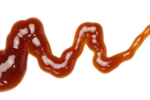 A smear of dark red barbecue sauce in a wave shape on an isolate, a Food & Drink Photo by ndanko
