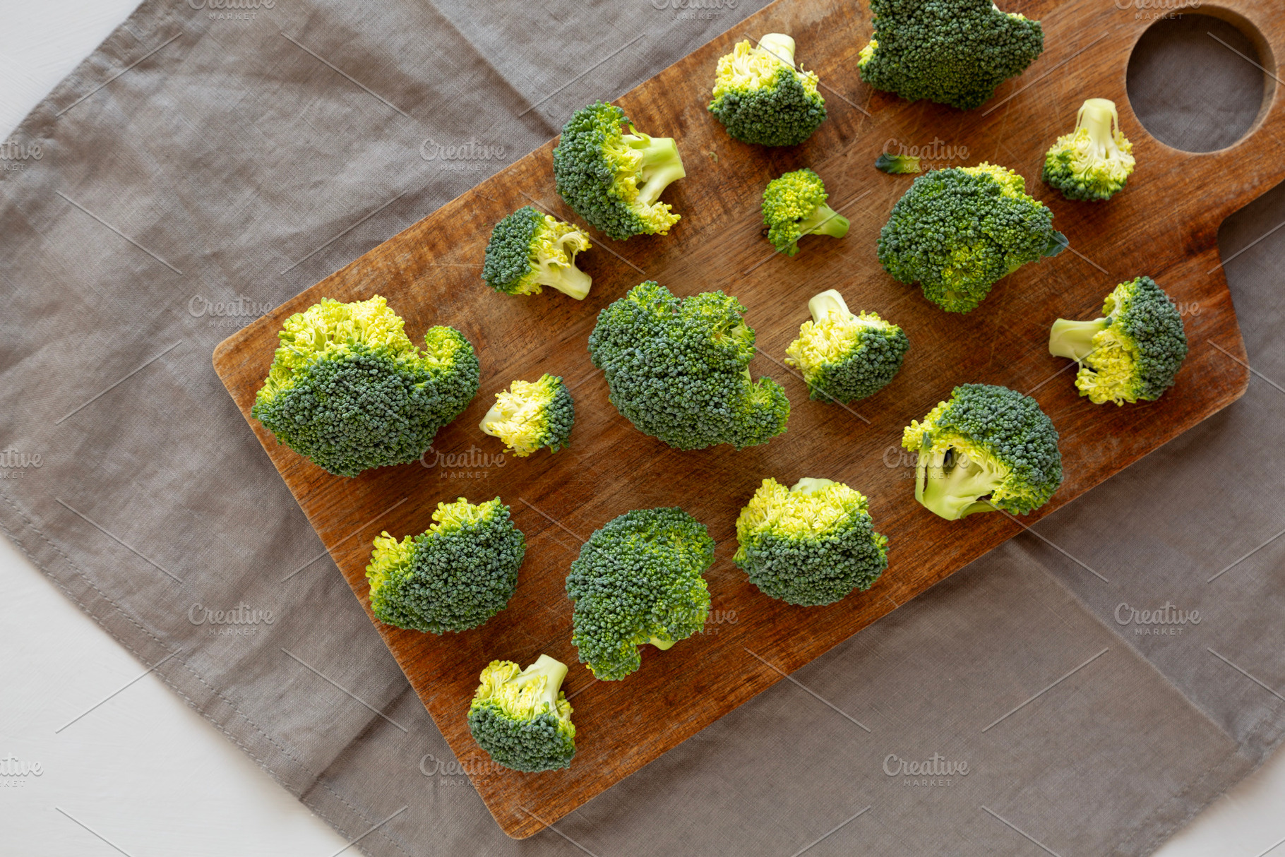 Raw Organic Green Broccoli on a Wooden Board, top view., a Food & Drink Photo by LiudmylaChuhunova