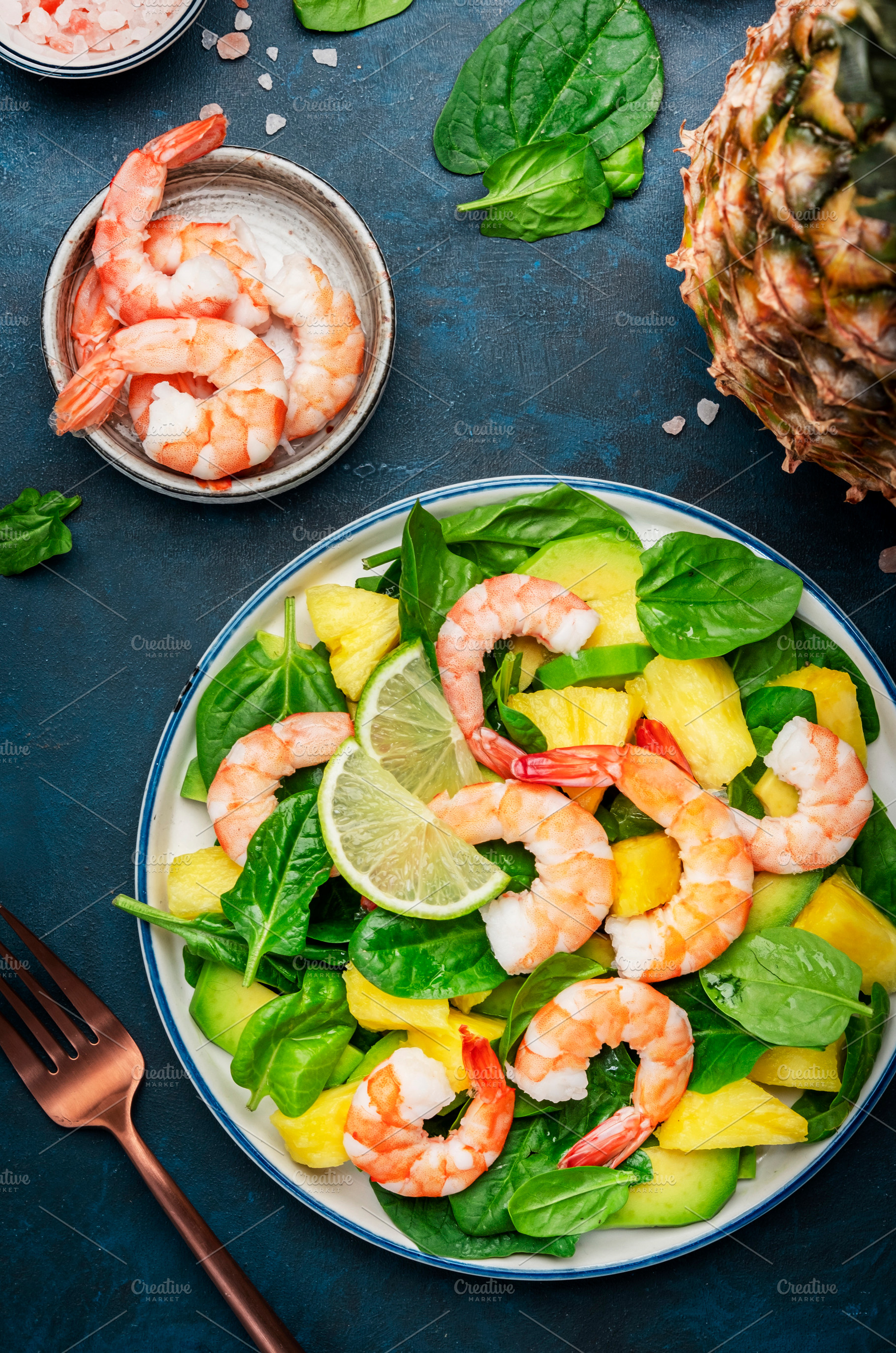 Fresh pineapple salad with shrimps, spinach, avocado and lime on, a Food & Drink Photo by 5PH