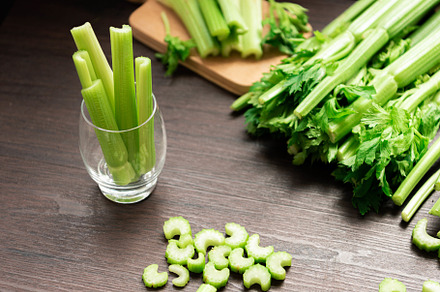 Bunch of fresh celery stalk on wooden table with leaves prepared, a Food & Drink Photo by Ministocker
