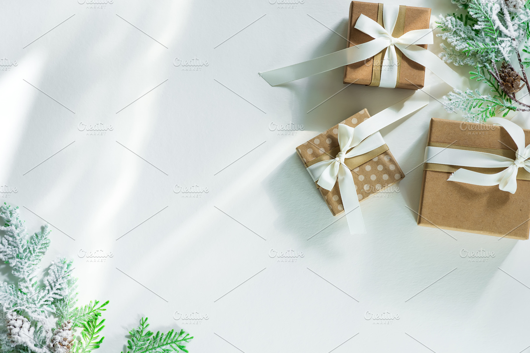 Gift boxes with snow fir branches containing xmas, card, and background, a Holiday Photo by YuMyart