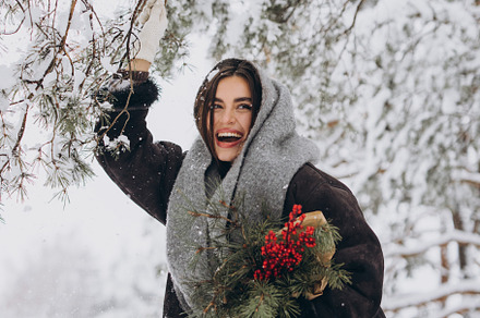 Happy woman holding winter bouquet, a Holiday Photo by Cherkas Photography