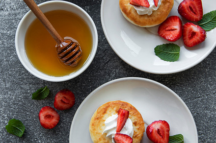 Cottage cheese pancakes, ricotta fritters on ceramic plate with, a Food & Drink Photo by Olena Rudo