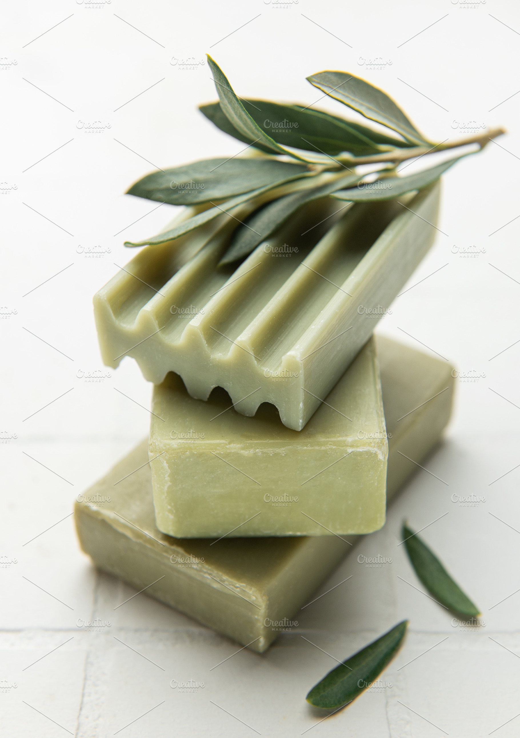 Olive soap bars forming a stack with olive branch on top, a Health & Medical Photo by Olena Rudo