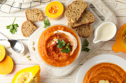 Composition with bowl of pumpkin soup on white wooden background, a Food & Drink Photo by AtlasStudio PRO