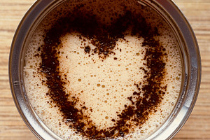 A close-up view of a cup of coffee with a heart-shaped pattern formed by coffee, an Industrial Photo by Textures & Backgrounds