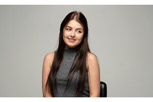 Young woman with a shy smile looking, a Person Photo by volodymyrshtun13795