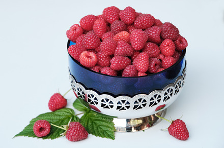 Fresh organic raspberries in a Vintage Glass Bowl with Metal Stand on white bac, a Food & Drink Photo by Rohan Photography