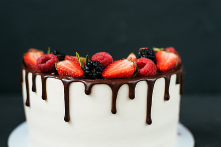 Round creamy cake on black background, with strawberry raspberries. Dietary white cream, with chocolate flavors., a Food & Drink Photo by byswat