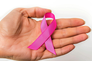 Pink ribbon in female hand, breast cancer, a Health & Medical Photo by AlyaAnd