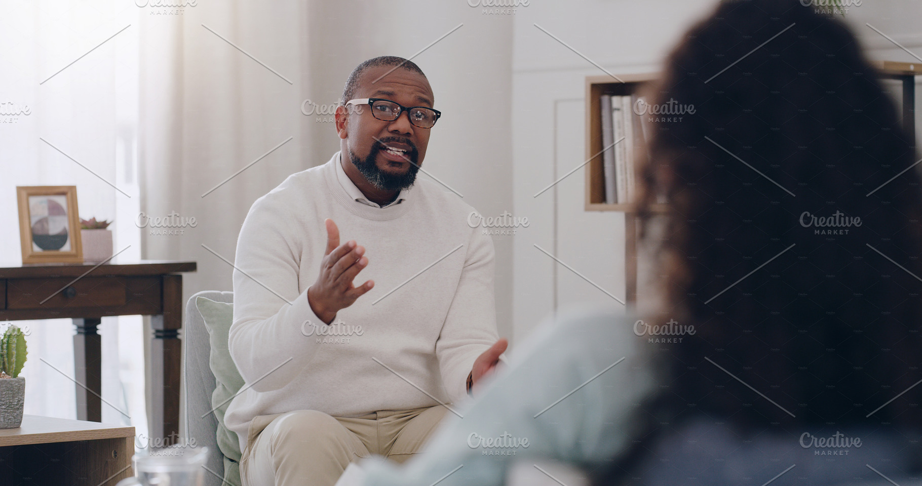 Therapy, support and psychologist talking to a woman about mental health, depression and anxiety. Psychology, healthcare and African therapist with advice for a patient while counseling in an office, a Photo by Peopleimages.com