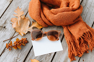 Vintage scarf and sunglasses create a warm autumn moodboard on wooden surface, a Beauty & Fashion Photo by AlyaAnd
