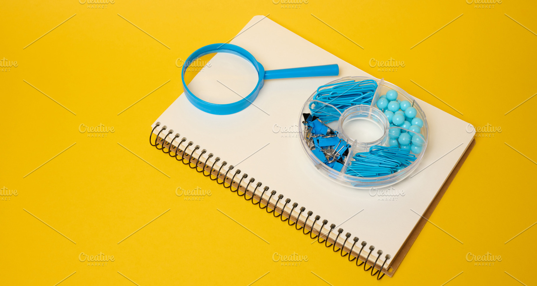 White notebook with blue magnifying glass and blue stationery in, a School & Education Photo by ndanko
