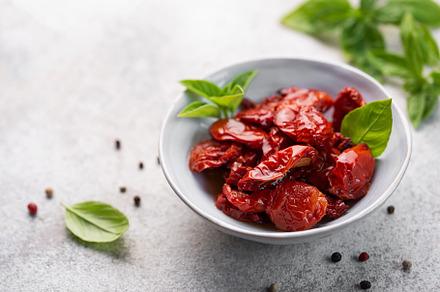 Bowl with sun dried tomatoes with fresh herbs and spices., a Food & Drink Photo by Olena Rudo