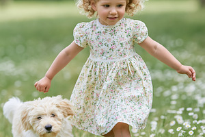 Young child and fluffy puppy playing outdoors in a sunny meadow,, a Person Photo by Studio ANNA